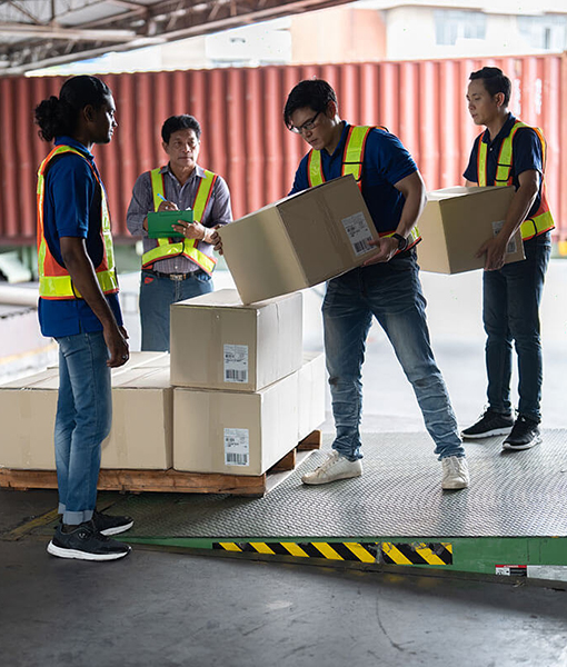 Warehouse staff checking inventory stock levels in storage facility